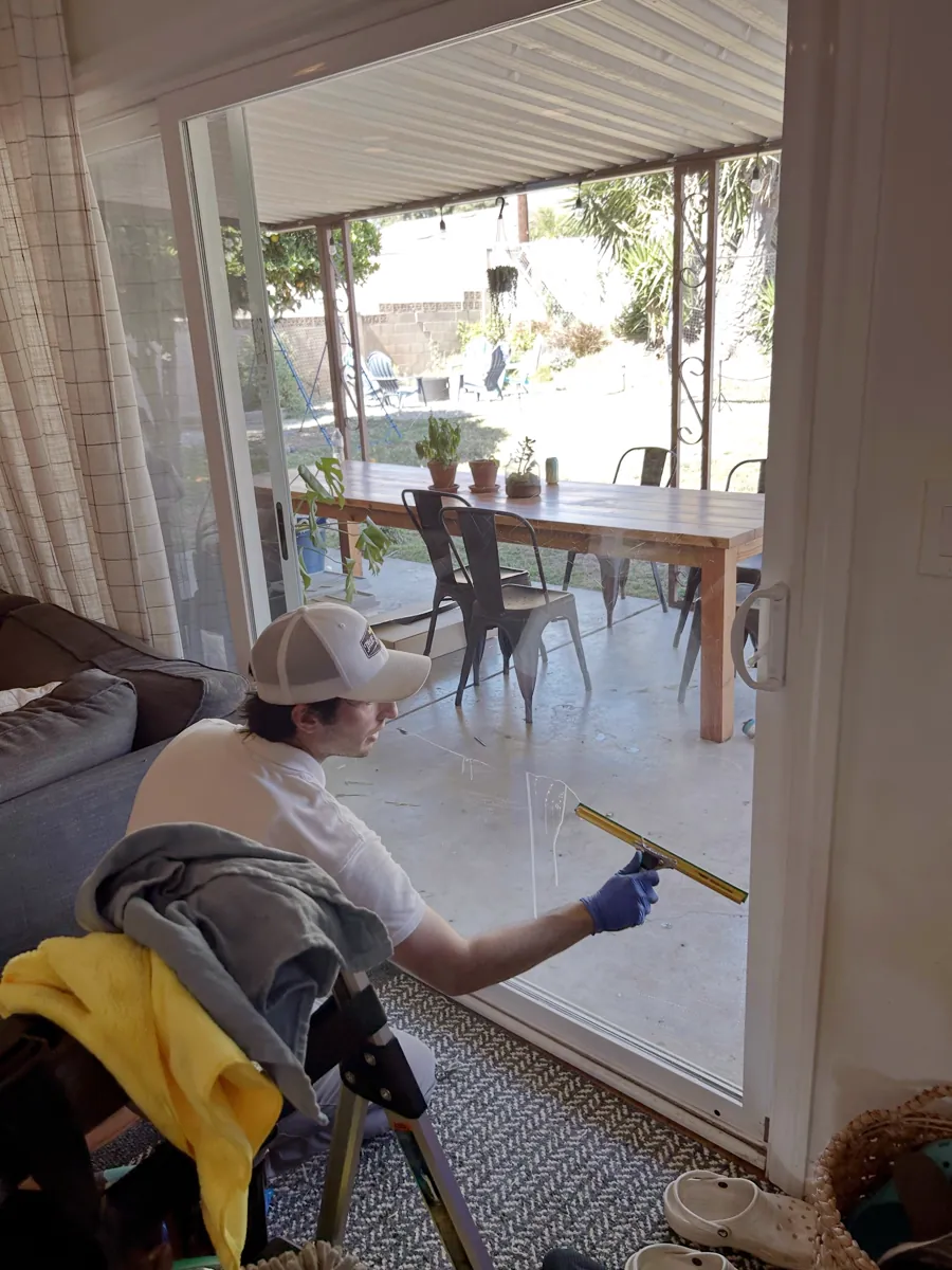 Technician detailing a residential window