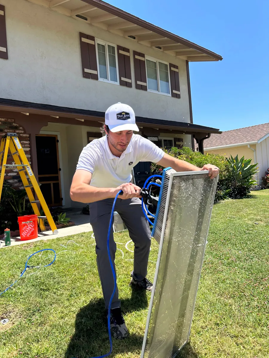 Technician repairing a window screen