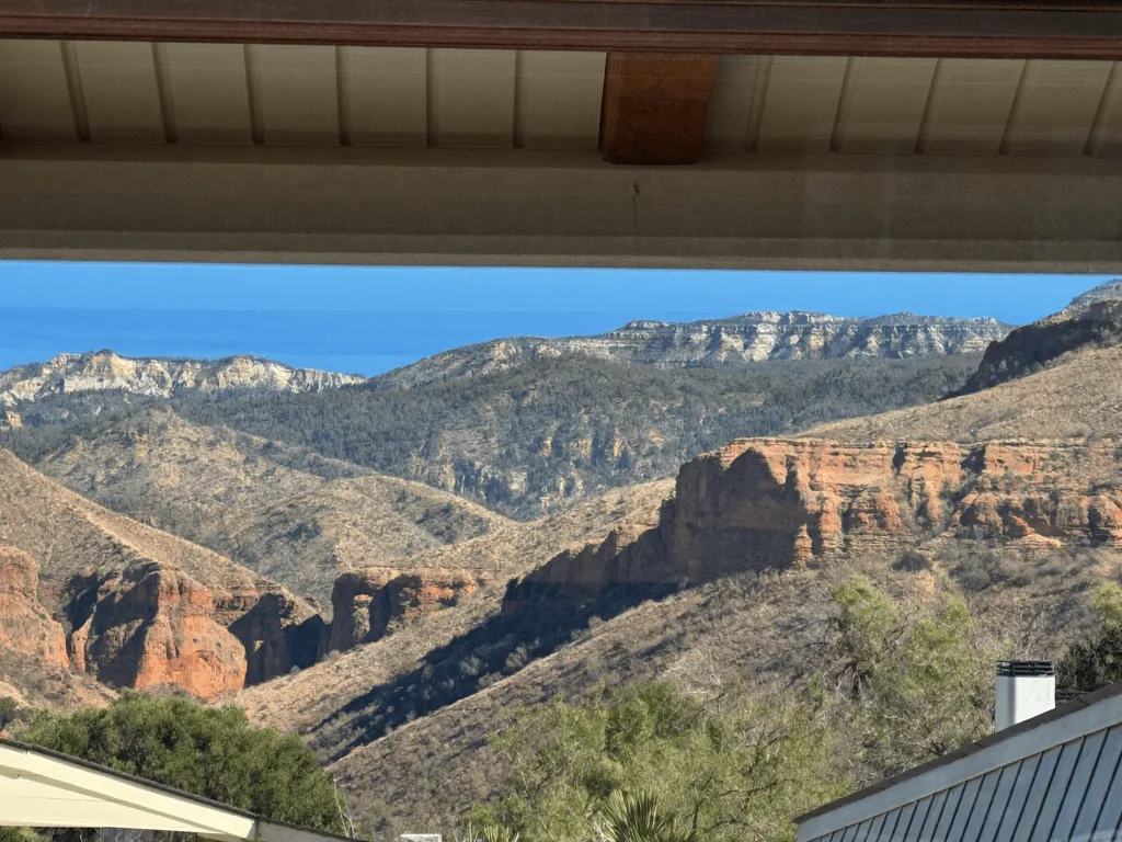 Mountain canyon valley view framed by a clean covered patio overhang
